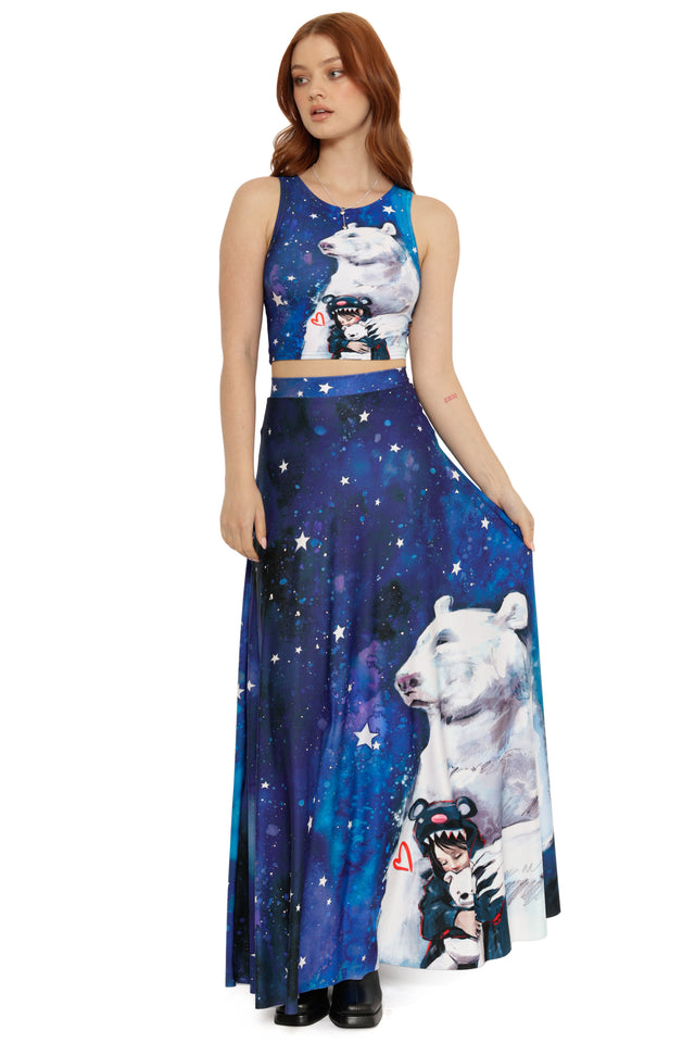 Woman wearing a blue dress with polar bear and space-themed designs on a white background