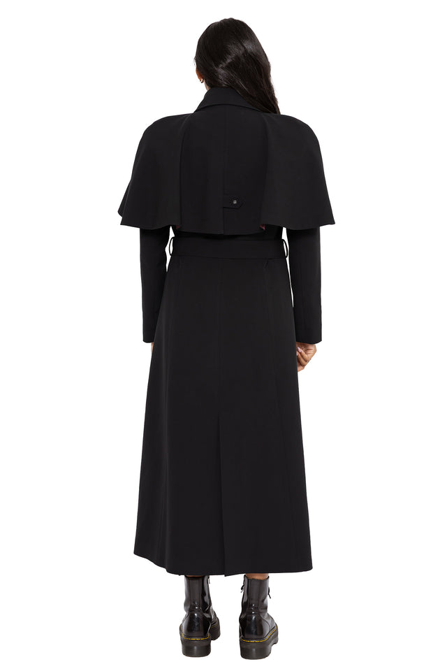 Whimsigoth black trench coat with a tailored silhouette, dramatic cape overlay and mystical spell inspired lining. This alternative goth outerwear piece blends gothic officewear and fantasy witch fashion with elegant structured styling.