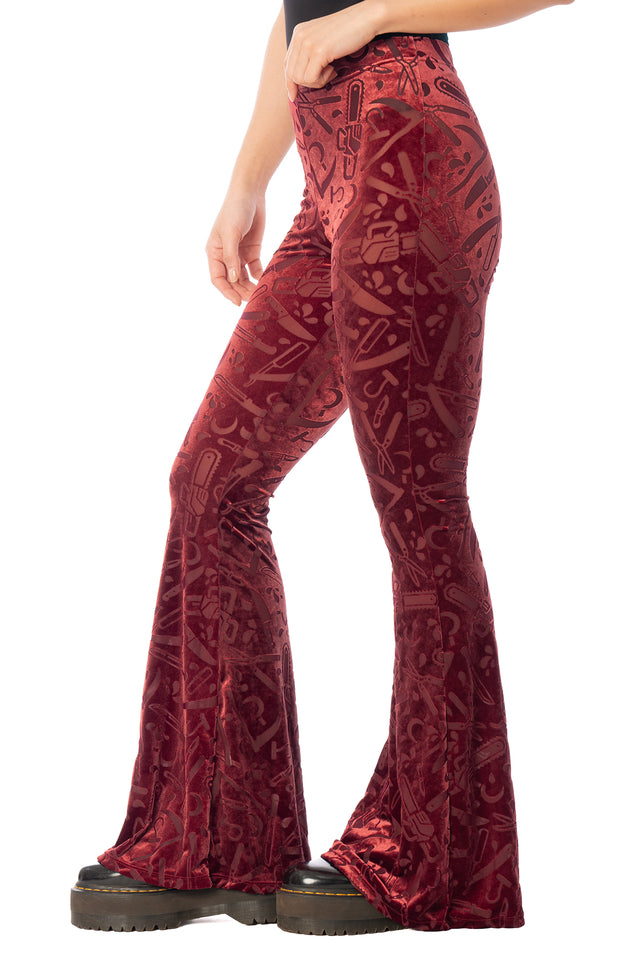 BlackMilk Slasher Burned Velvet Flare Pants – red horror slasher weapon print burned velvet high-waisted flare Halloween pants, part of the BlackMilk Clothing Halloween collection