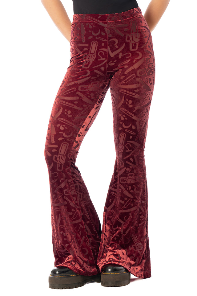 BlackMilk Slasher Burned Velvet Flare Pants – red horror slasher weapon print burned velvet high-waisted flare Halloween pants, part of the BlackMilk Clothing Halloween collection