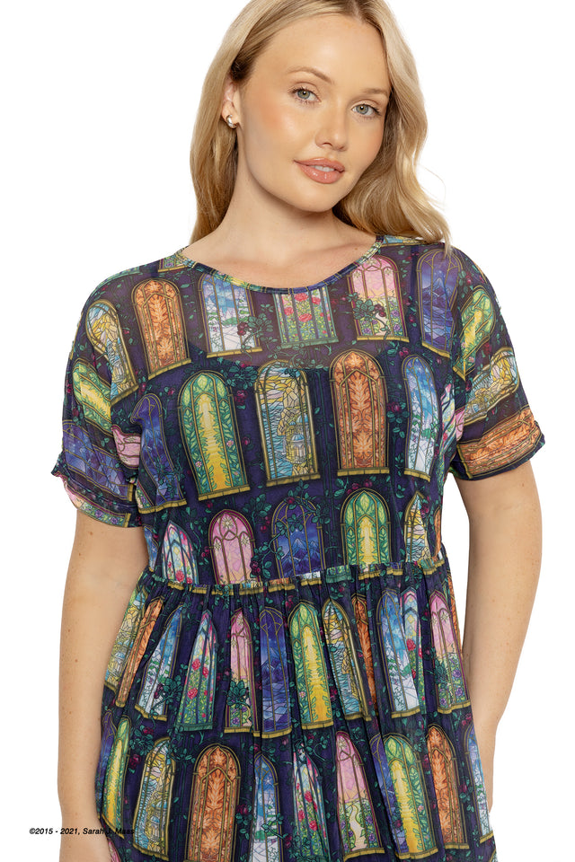 A Court of Thorns and Roses Courts of Prythian dress, ACOTAR inspired sheer smock dress by Sarah J Maas with colourful stained glass print, loose silhouette, short sleeves and flowing tiered skirt, fantasy fashion piece