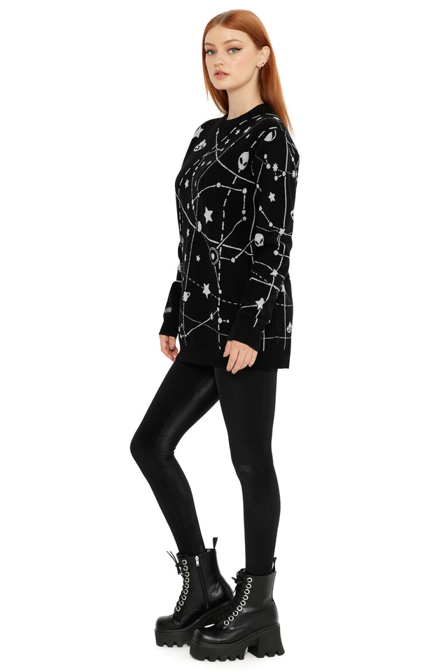 Celestial knit jumper with white constellation artwork and space icons on a black background