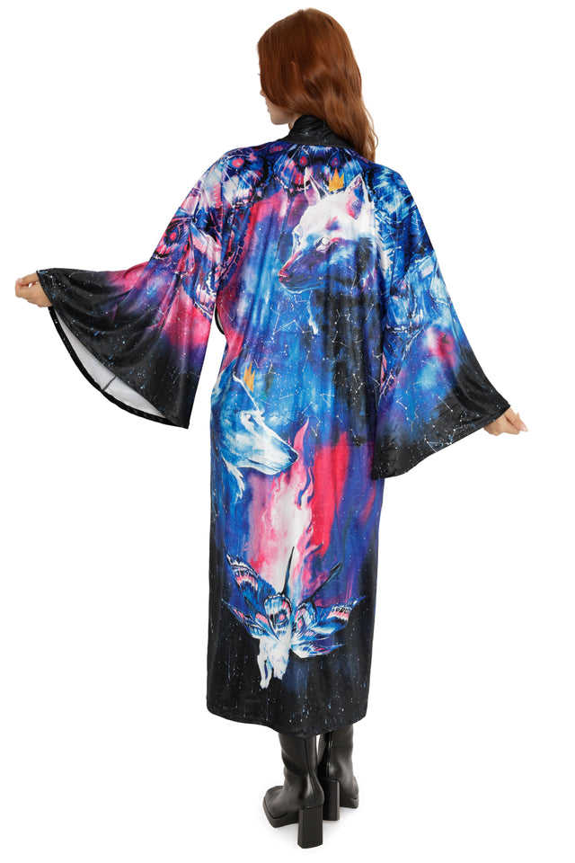 Woman wearing a colorful kimono-style garment with abstract designs on a white background
