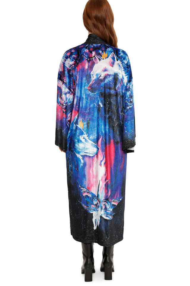 Person wearing a colorful coat with abstract designs on a white background