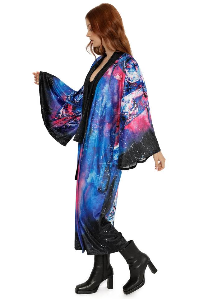 Woman wearing a colorful, patterned kimono-style garment on a white background