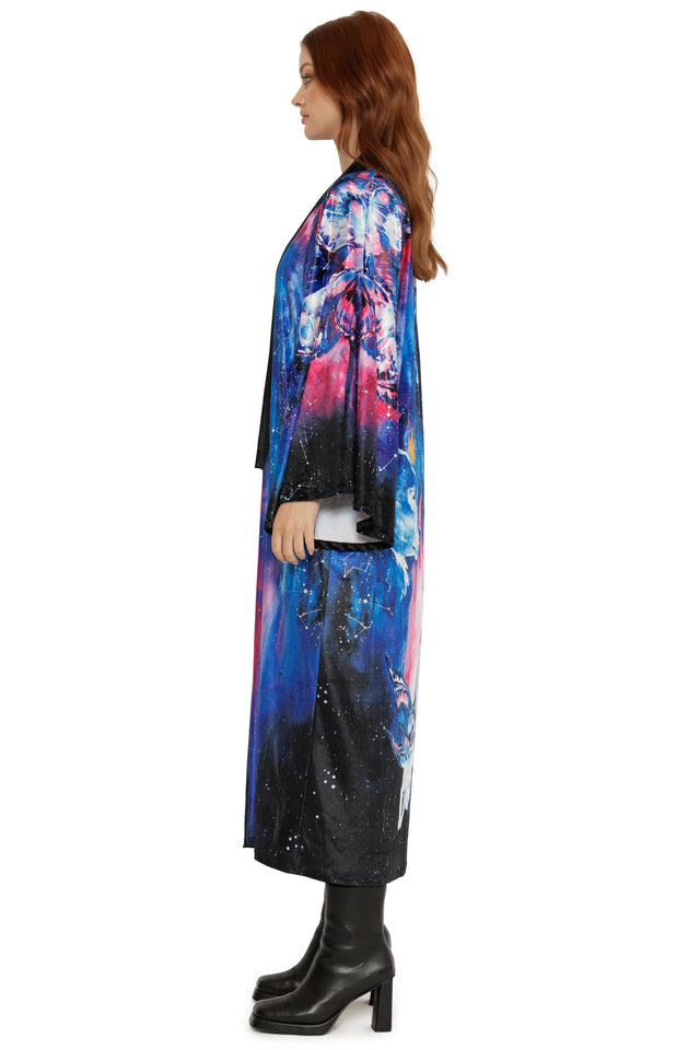 Woman wearing a colorful, patterned coat on a white background