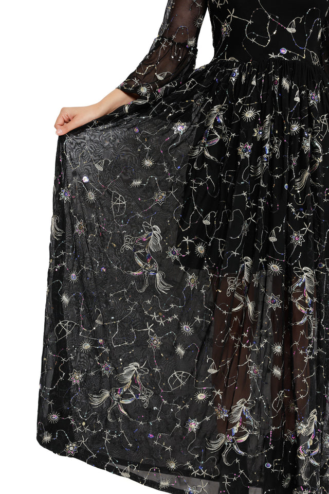 Celestial-inspired black maxi dress with sheer fabric, embroidered stars and a fitted bodice