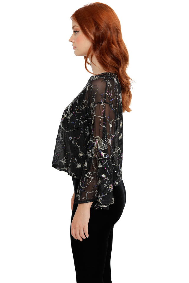 Black mesh top featuring embroidered celestial symbols, stars and flowing bell sleeves