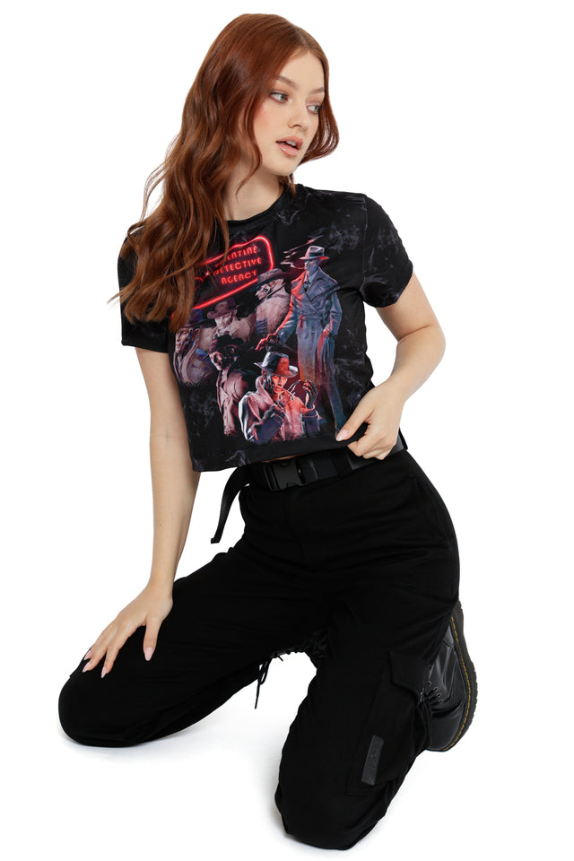 Model styled in Fallout x BlackMilk Be My Valentine Baby Tee showcasing neon red heart sign and detective character print.