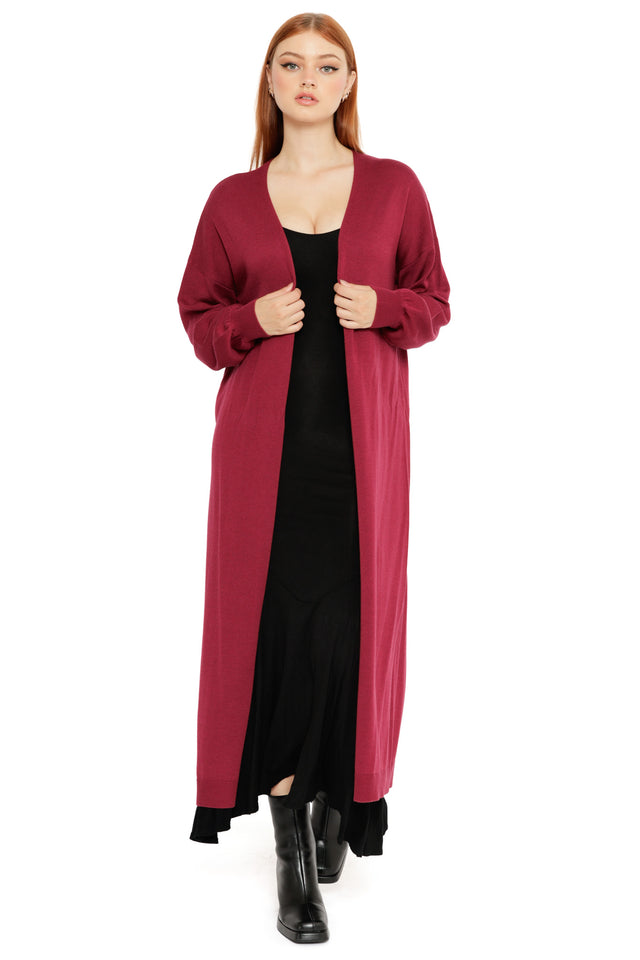 Model styled in the Berry Super Cardigan, a soft knit long cardigan in a berry red shade with draped open front and easy relaxed fit
