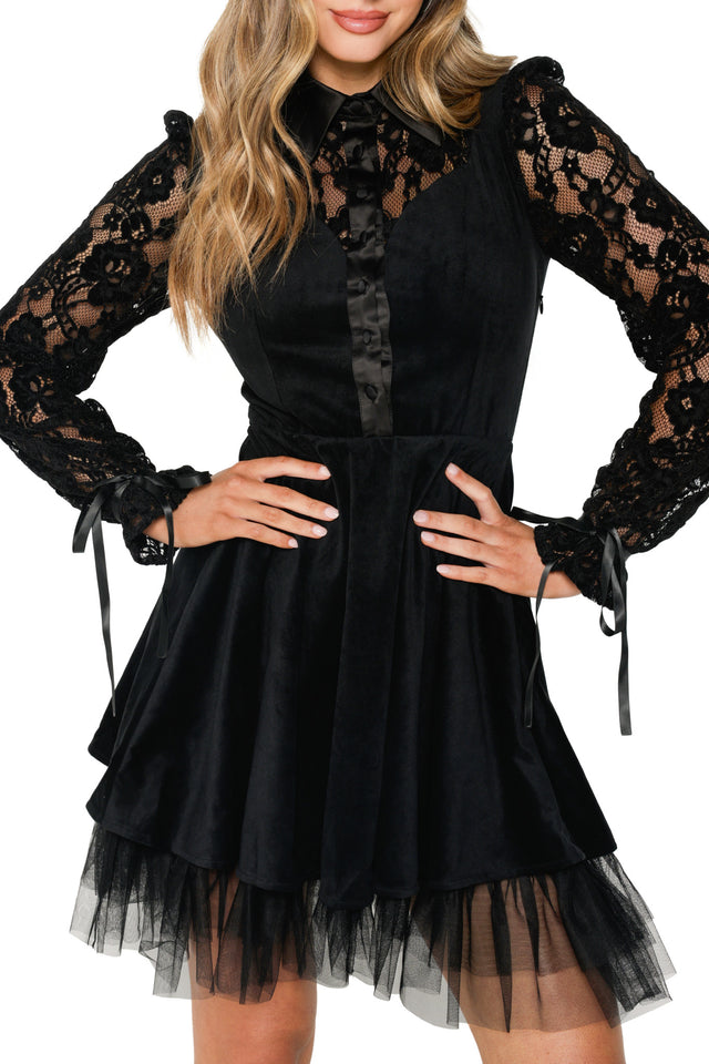 Black lace dress with long sleeves and a tiered skirt on a white background