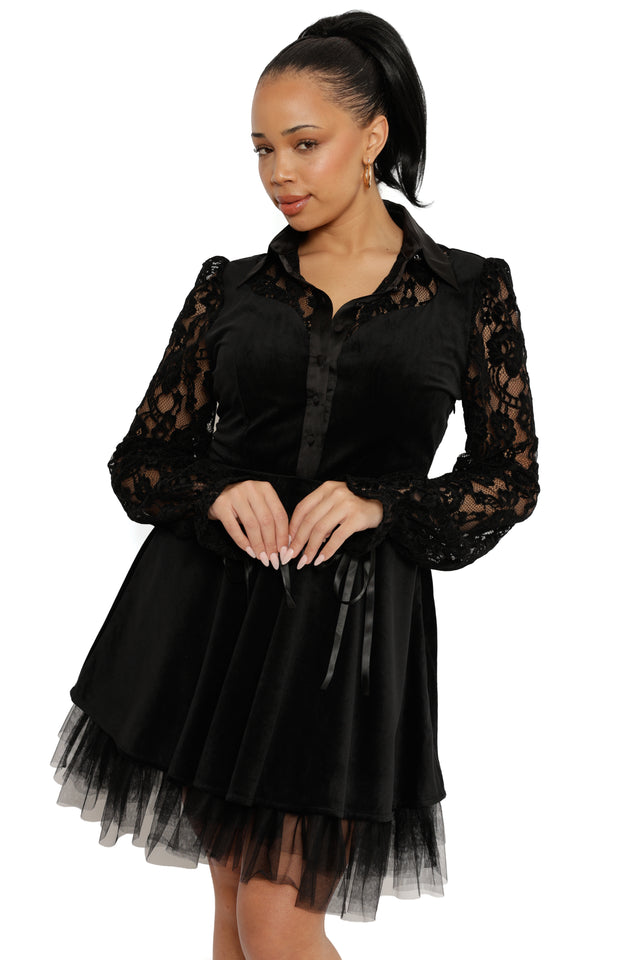 Woman wearing a black lace dress on a white background