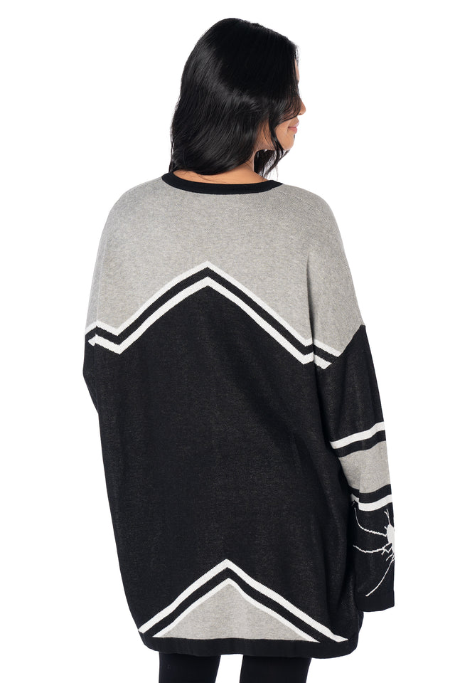 Women's oversized black hockey jersey with varsity-inspired stripe detailing, broken heart sleeve graphics, relaxed fit and bold BlackMilk branding across the front.
