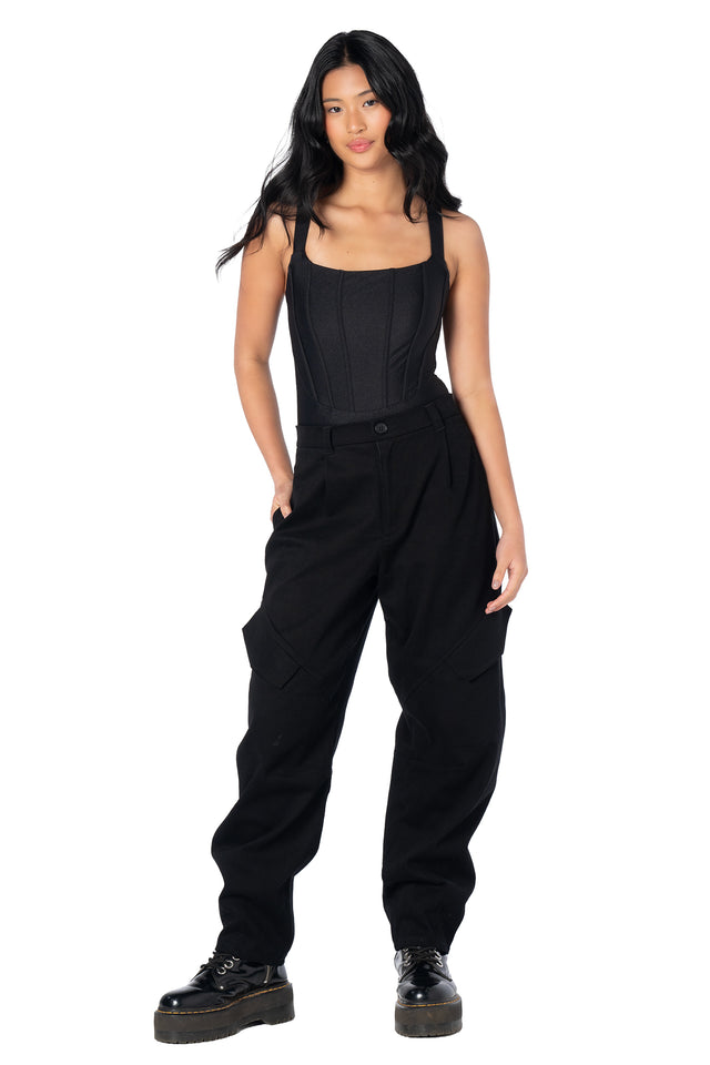 Black barrel leg cargo pants featuring a relaxed silhouette, oversized utility pockets, stretch cotton fabric and seam panel detailing for comfortable everyday streetwear and alternative fashion.
