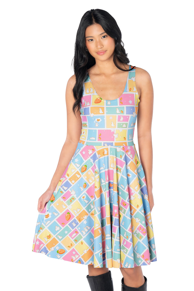 Pastel longline tee dress featuring an all-over bunny postage stamp print with carrots, fluffy clouds and stars, complete with a relaxed knee-length silhouette and practical side pockets.
