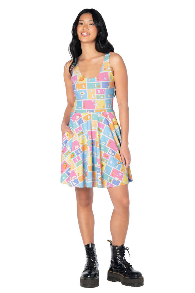 Pastel bunny-themed skater dress with an all-over print of rabbit postage stamps, carrots, stars and clouds, finished with a flattering scoop neckline and flowing skirt.