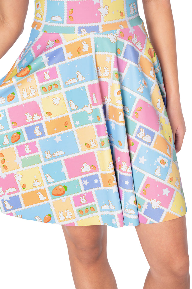BlackMilk bunny stamp scoop skater dress featuring adorable rabbit illustrations, pastel postage stamp artwork, twirl-ready skater skirt and functional side pockets.