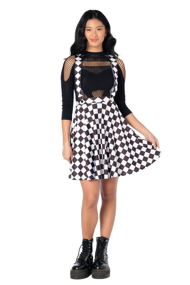 BlackMilk black suspender dress with detachable straps, skater silhouette, soft matte fabric and side pockets, perfect for alternative and vintage fashion lovers.