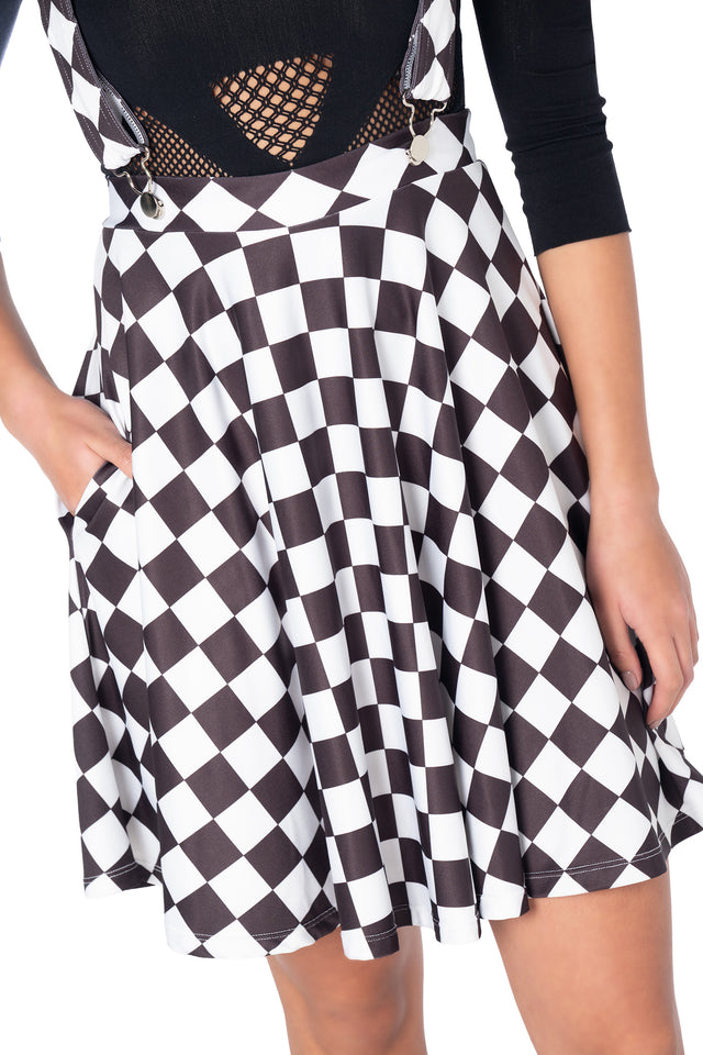 Women's black skater dress featuring removable suspender straps, stretch fabric, hemmed skirt and functional pockets for a classic retro streetwear look.