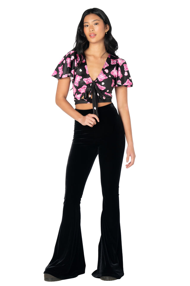 Playful cropped top featuring an all-over gummy bear skeleton print, glossy Luxe fabric, flounced sleeves, removable tie detail and a flattering front cut-out silhouette.