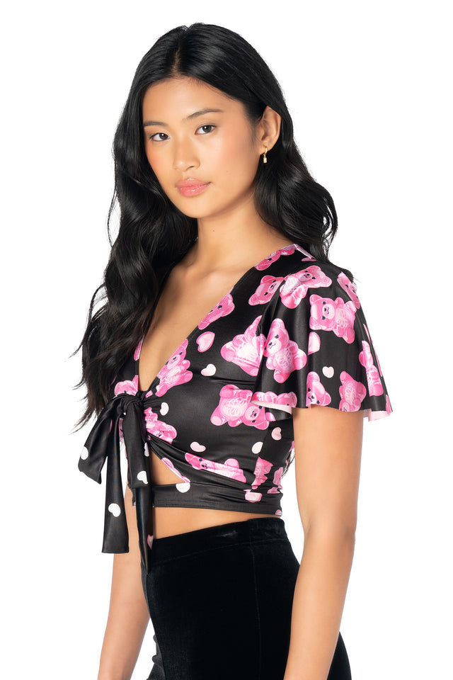 BlackMilk cropped Rio top featuring playful gummy bear skeleton artwork, lightweight Luxe fabric, flounced cap sleeves, front cut-out detail and a removable tie for versatile styling.