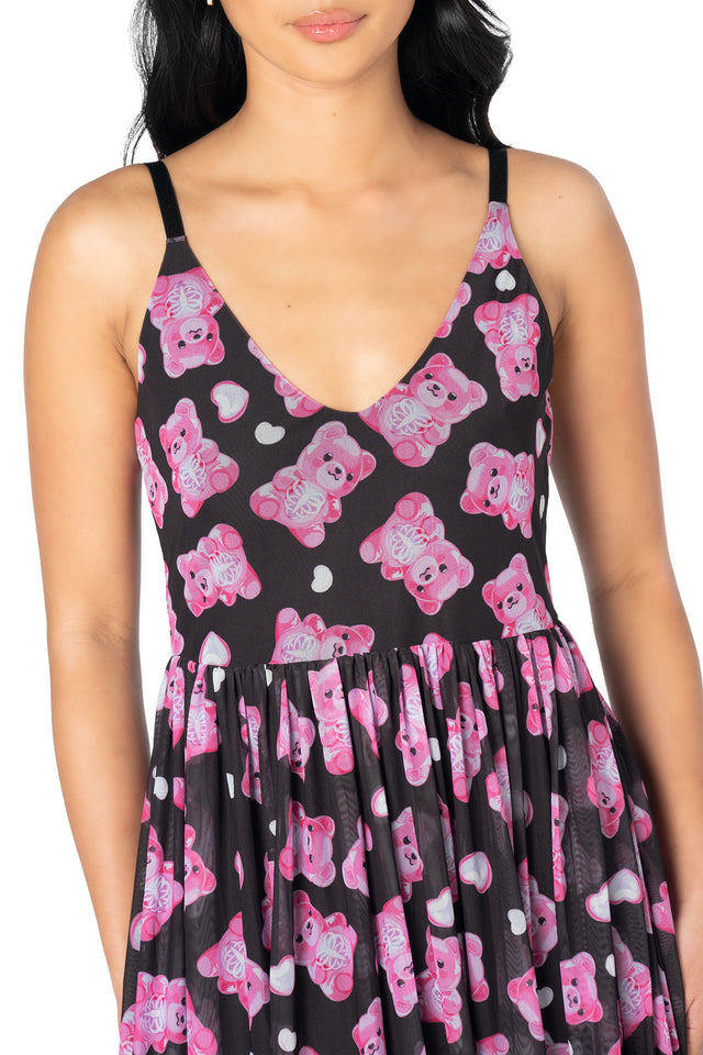 BlackMilk sheer midaxi dress featuring playful pink gummy bear graphics, floaty mesh fabric, adjustable straps and a lined skirt for effortless alternative styling.