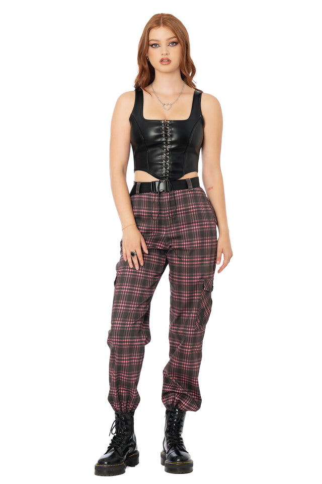 Pink tartan utility cargo trousers featuring oversized functional pockets, removable belt, vegan leather patch details and a comfortable relaxed streetwear fit.