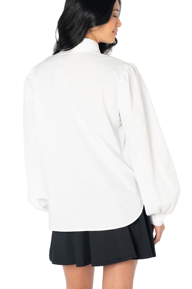 Classic white button-up shirt with an oversized removable bow, statement balloon sleeves and a lightweight woven construction for polished everyday outfits.