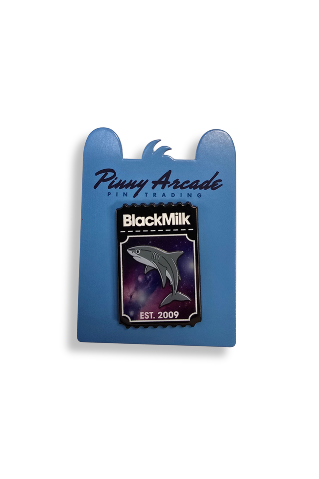 Pin with a shark design on a blue card featuring 'Pinny Arcade' and 'BlackMilk' branding.