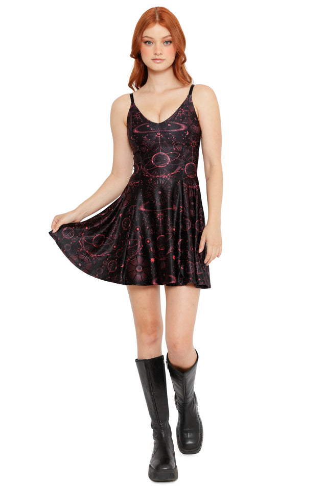 Sleeveless BlackMilk skater dress with deep red cosmic symbols, planetary rings and star charts
