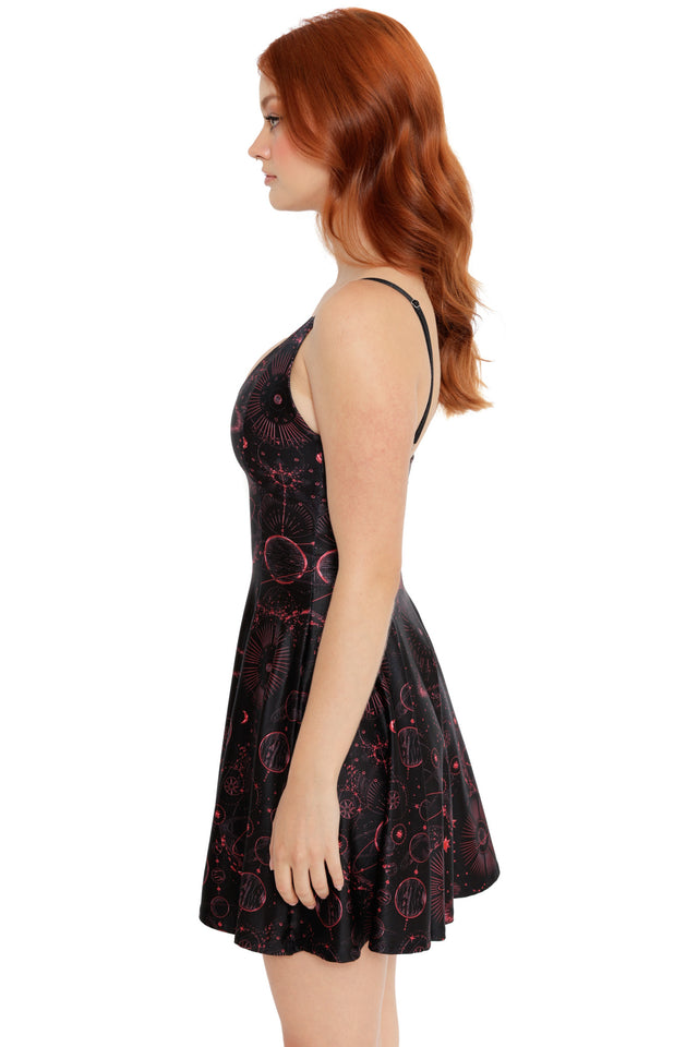 Red and black celestial skater dress with fitted top and flowing skirt, featuring detailed cosmic illustrations