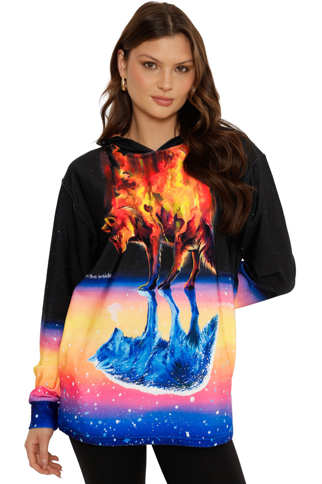 Woman wearing a hoodie with a colorful wolf design on a white background