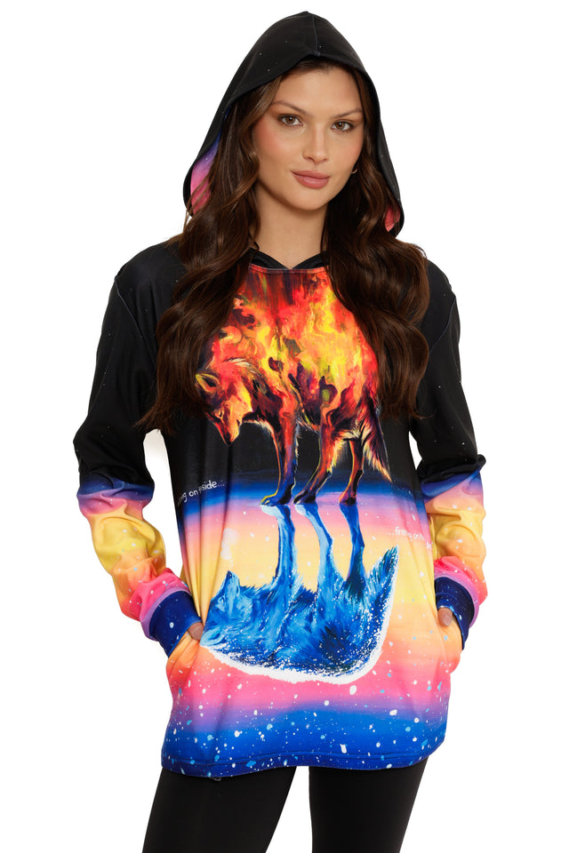 Woman wearing a hoodie with a colorful wolf design on a white background