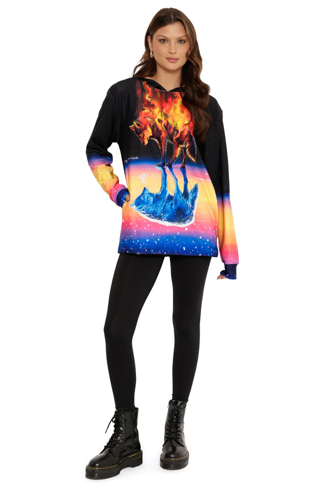 Person wearing a colorful hoodie with a wolf design on a white background