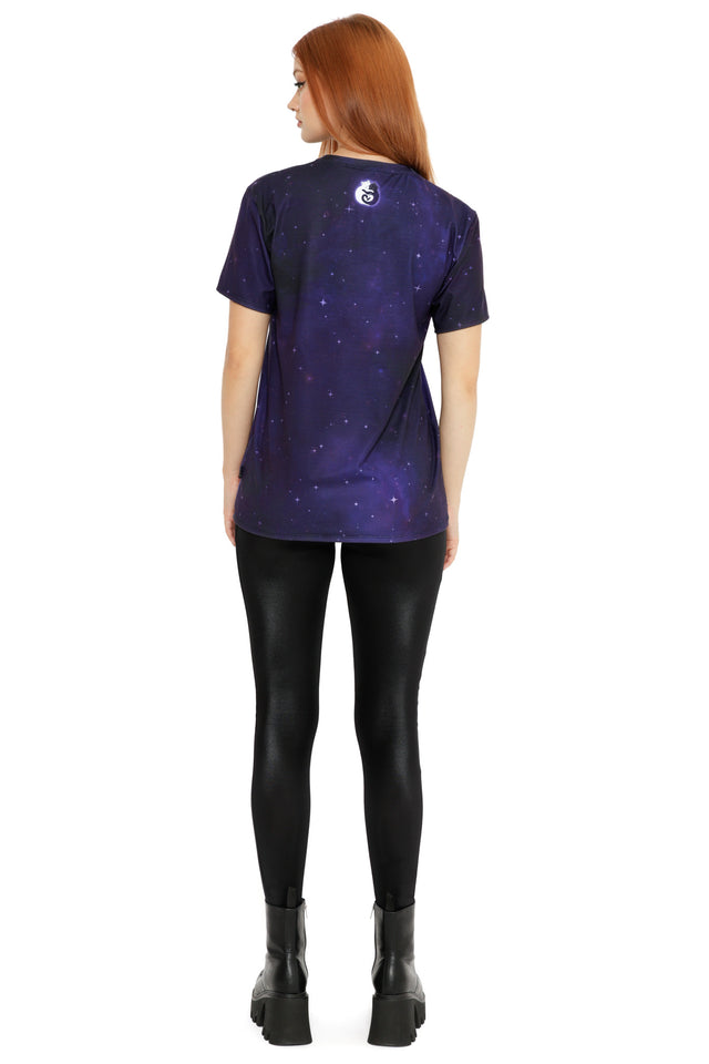 Front view of a cosmic purple T-shirt showcasing glowing cats in different curled poses, inspired by lunar phases, worn with black pants.