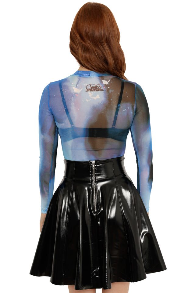 Person wearing a sheer long-sleeve top with a blue gradient and a black PVC skirt on a white background.