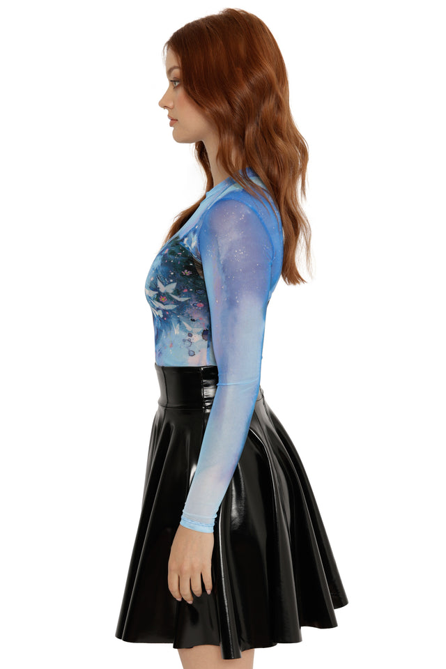 Woman wearing a black PVC skirt and a blue sheer top with a patterned design.