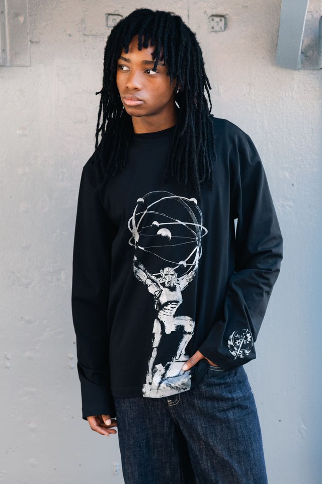 Model wearing Fallout x BlackMilk Chain That Binds Long Sleeve Boyfriend Tee featuring Brotherhood of Steel statue print in grey.