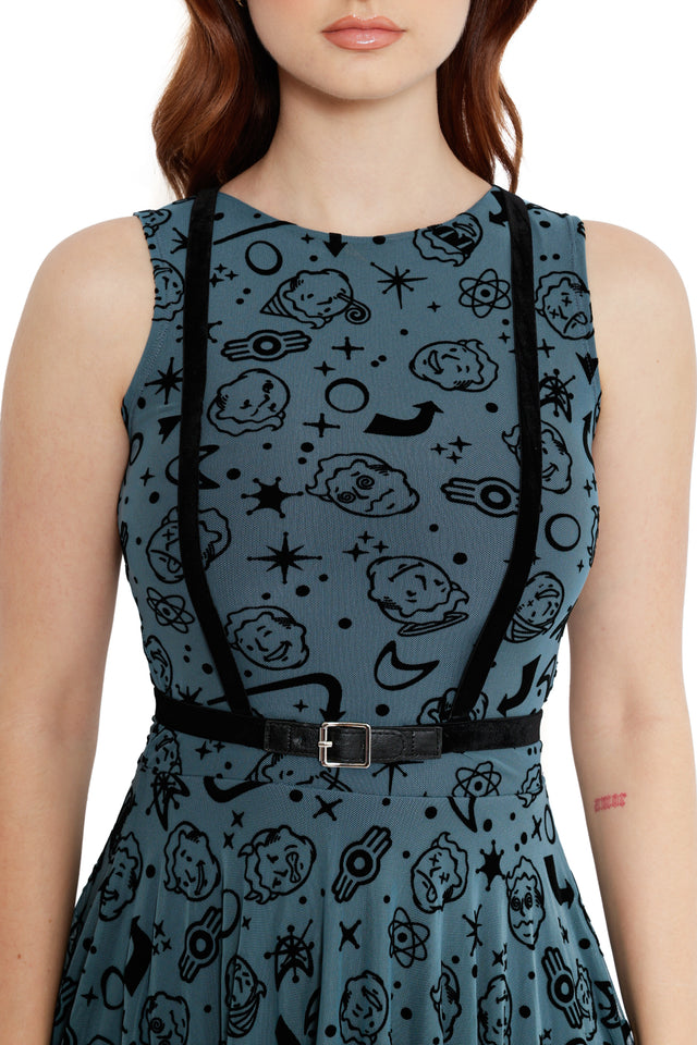 Model wearing Fallout x BlackMilk Vault Boy print dress with belted waist and layered handkerchief hemline.