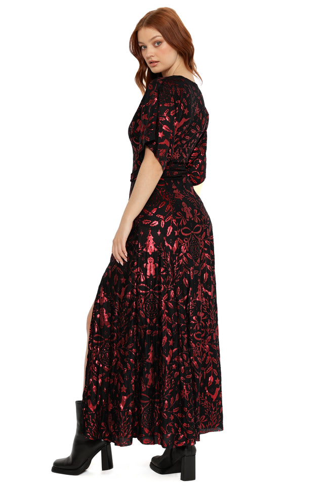 Woman wearing a black and red patterned dress on a white background