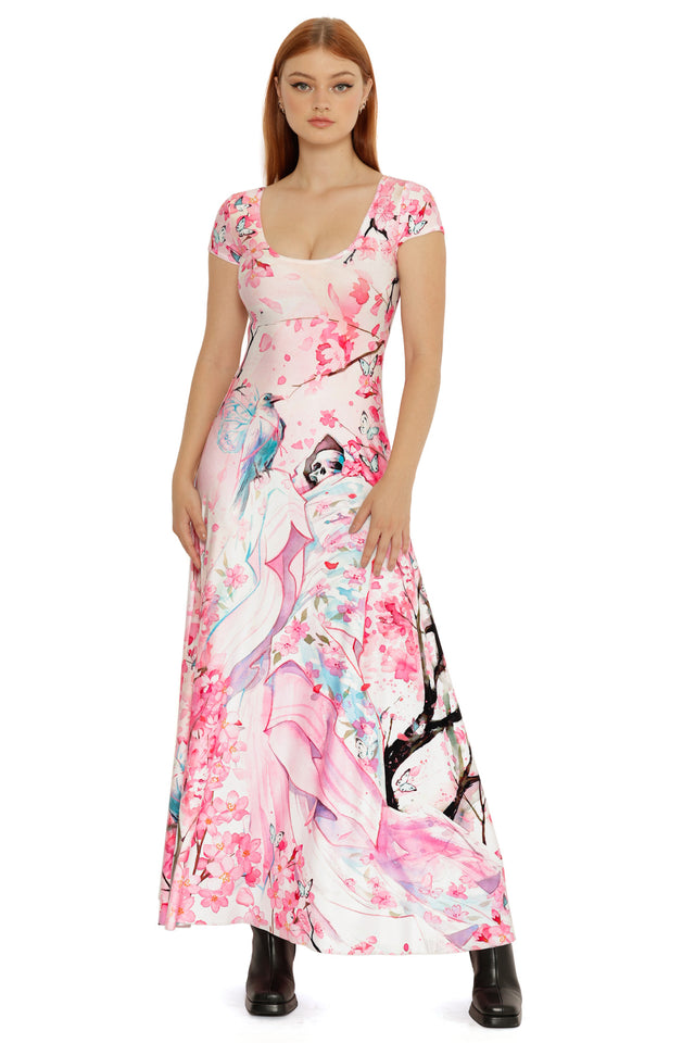 Pink illustrated maxi dress with cap sleeves, detailed with cherry blossom florals, butterflies, and ethereal figures throughout the print.