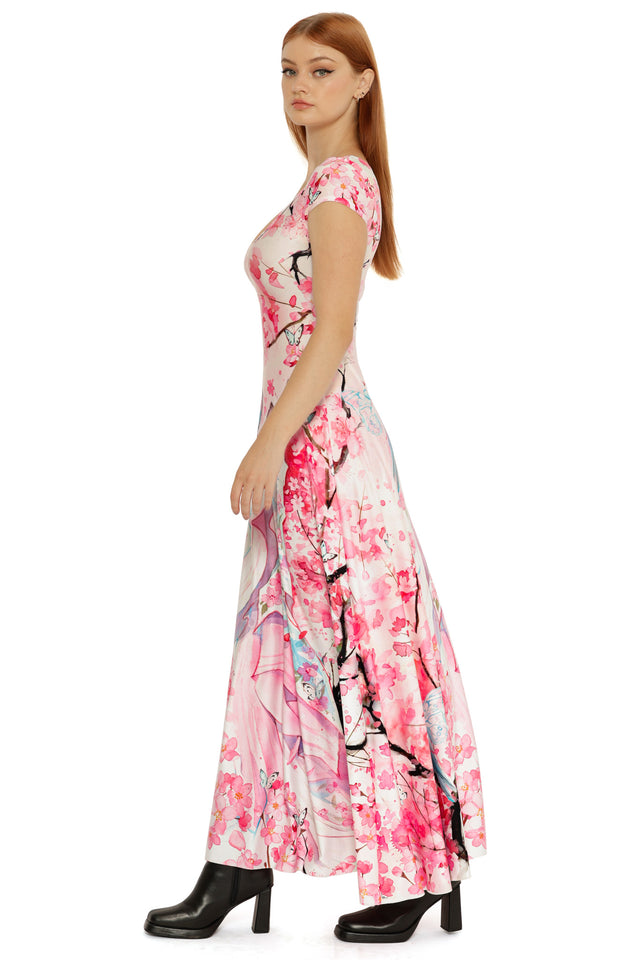 Cap sleeve maxi dress in soft pastel tones, featuring an illustrated figure surrounded by pink blossoms and delicate linework.