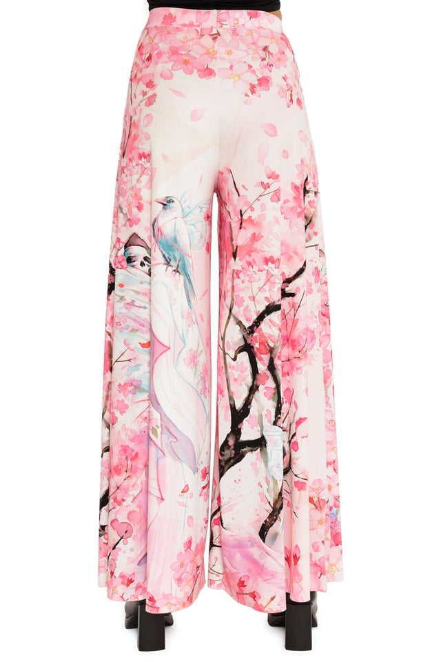 Floral and bird patterned pants on a white background