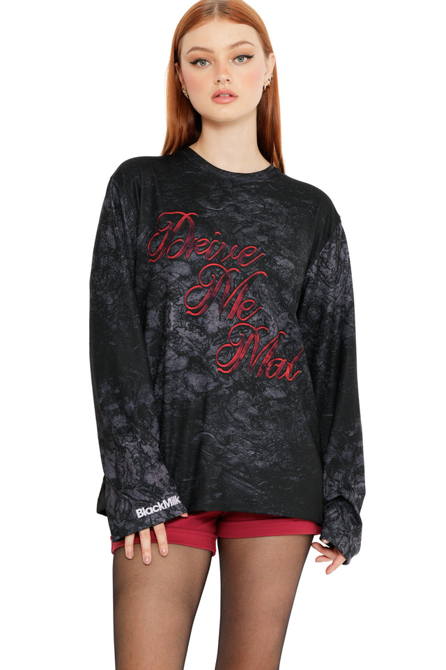 Model wearing the Drive Me Mad Long Sleeve Oversized Boyfriend Tee from the Wuthering Heights collection, a black washed long sleeve tee with red script text and relaxed oversized fit