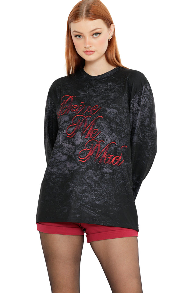 Front view of the Drive Me Mad Long Sleeve Oversized Boyfriend Tee, featuring gothic red lettering on a black textured fabric with slouchy oversized silhouette