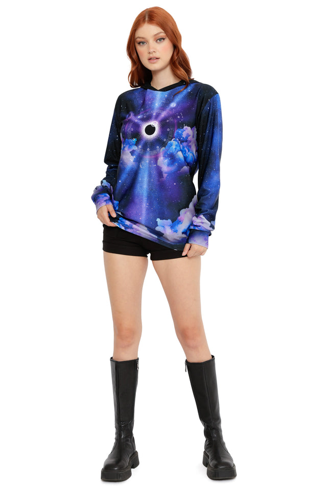 Cosmic hoodie top with celestial artwork, starry night sky background and dramatic eclipse motif