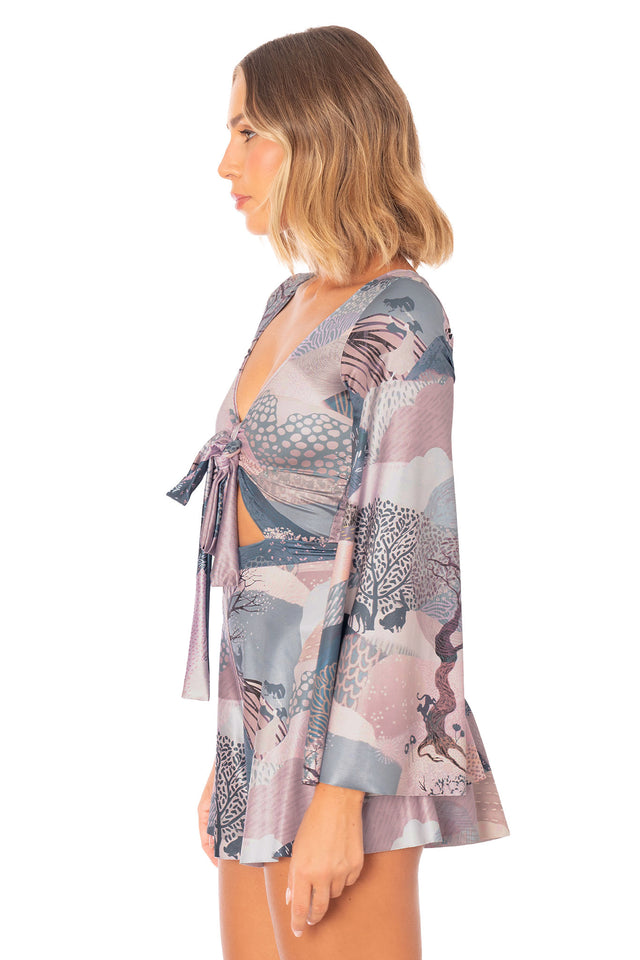 Printed playsuit with long statement sleeves, tie front bodice and abstract twilight inspired artwork
