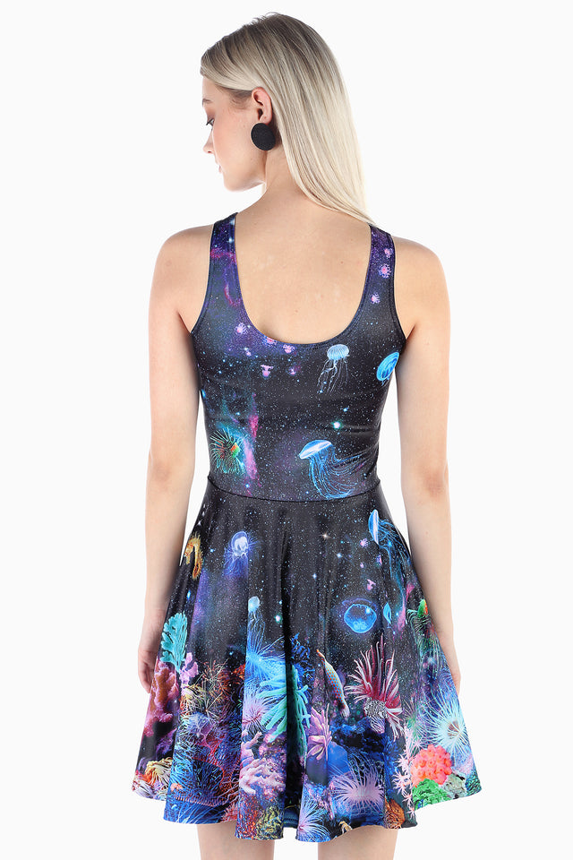 BlackMilk reversible skater dress in ocean galaxy print, fit and flare shape with scoop neckline, vibrant coral reef and jellyfish design, stretchy fabric with pockets