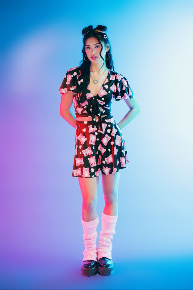 Cute alternative cropped Rio top featuring vibrant gummy bear skeleton artwork, soft shiny Luxe fabric, flutter sleeves, front cut-out detail and a removable tie for versatile everyday or party styling.
