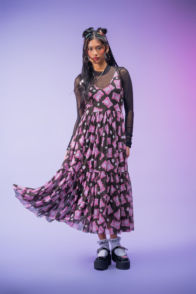 Sheer black mesh midaxi dress featuring an all-over pink gummy bear print, adjustable straps, floaty layered fabric and a lined skirt for a playful alternative look.
